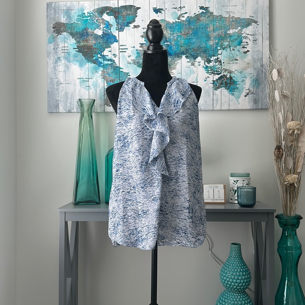 Blue and white shirt with no sleeves with line design and collar. Zac & Rachel.